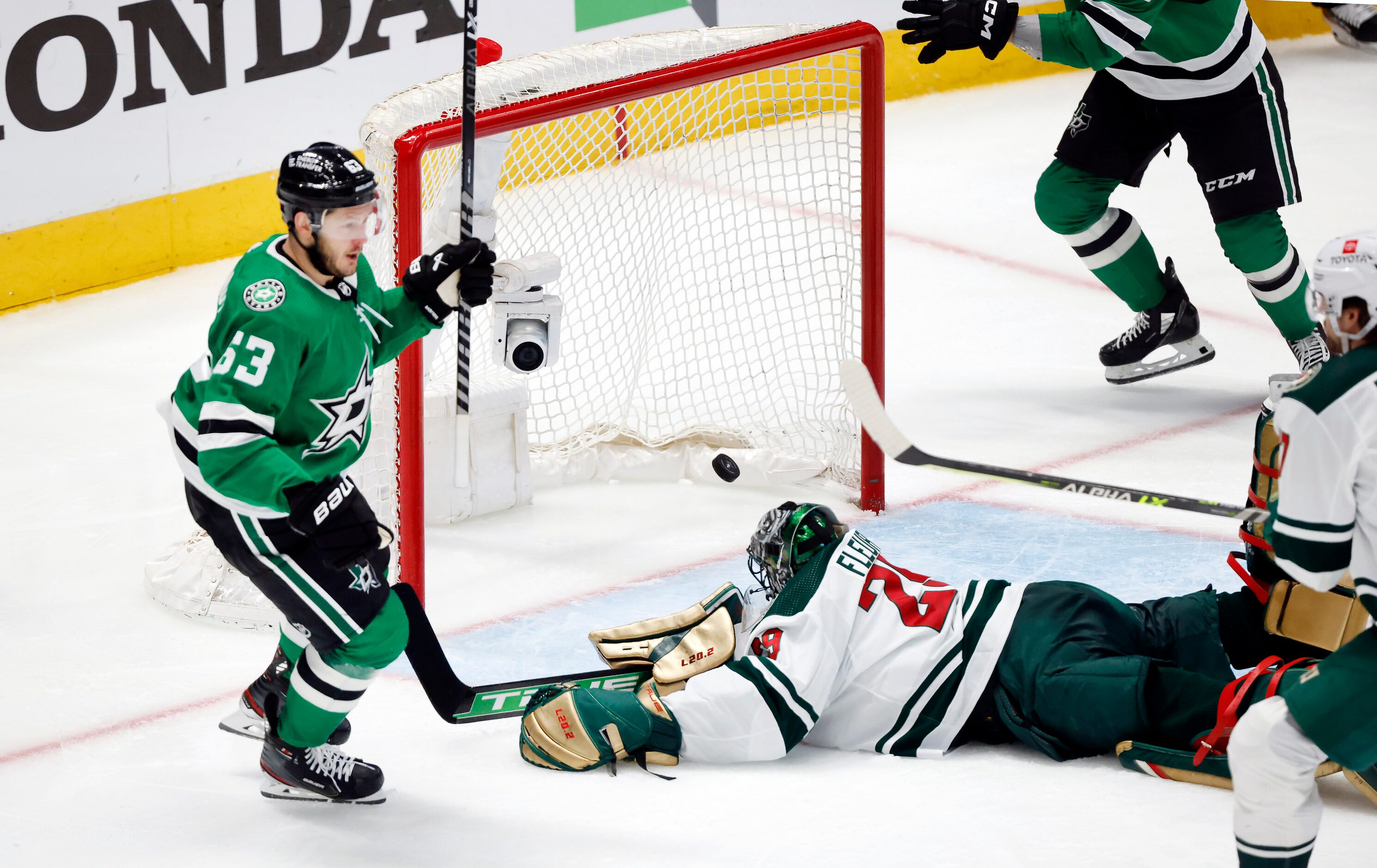 Dallas Stars right wing Evgenii Dadonov (63) scores on Minnesota Wild goaltender Marc-Andre...