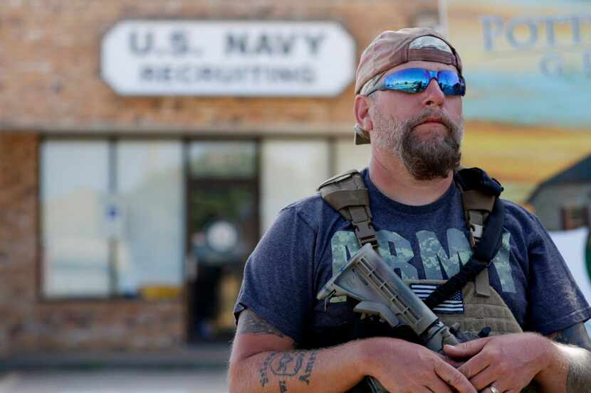 
Terry Jackson stands guard outside a military recruitment center in Cleburne.
