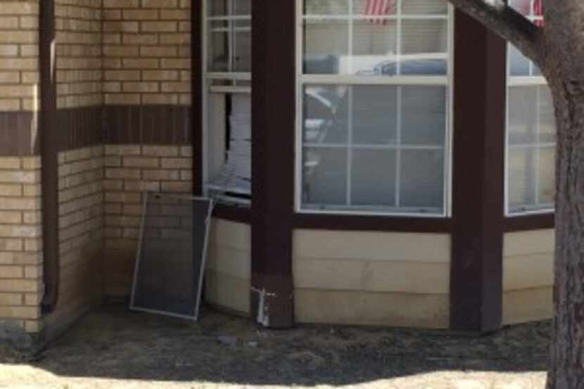  The window at Green's home was knocked out and later boarded up Thursday.