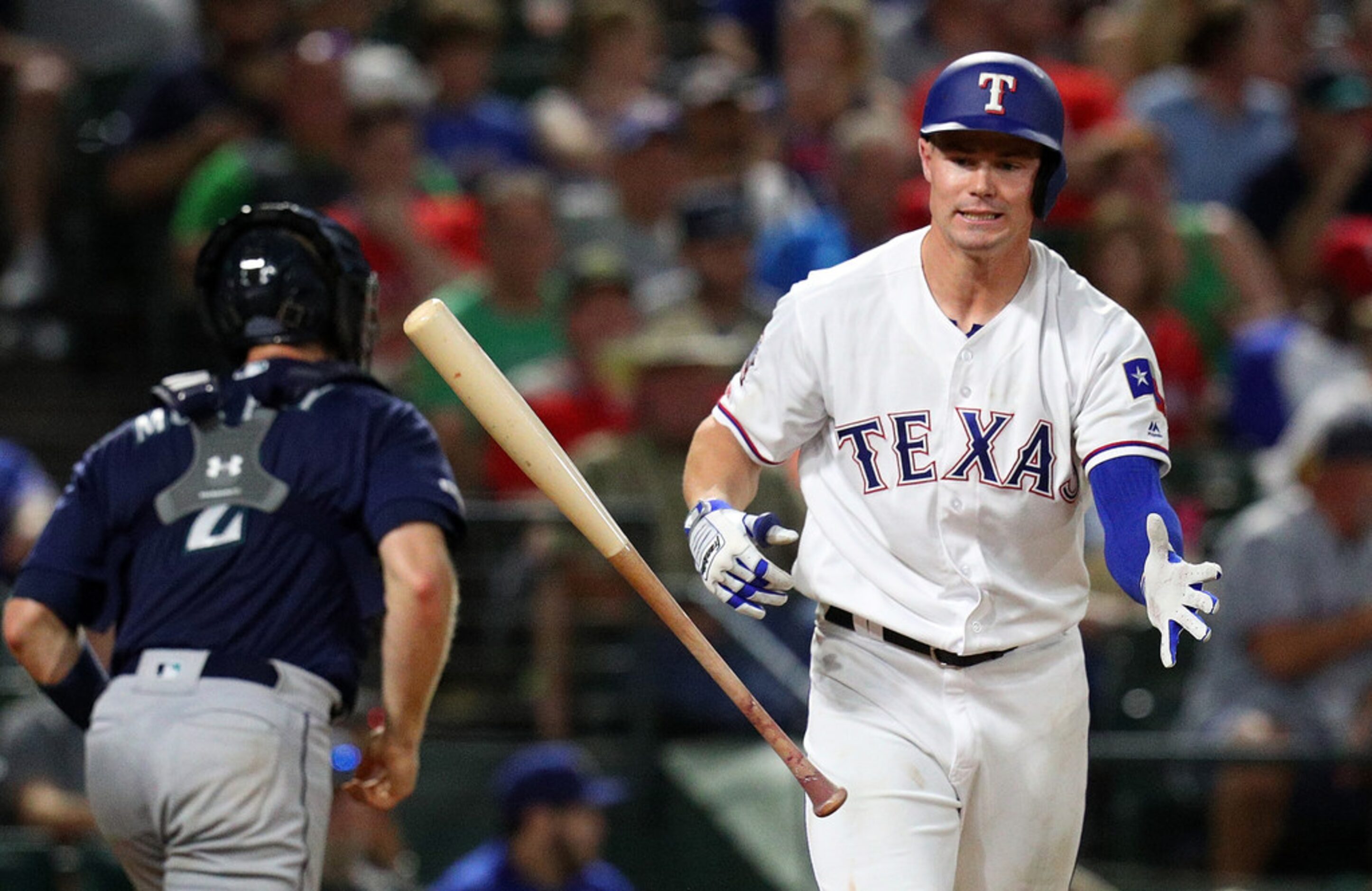 ARLINGTON, TEXAS - AUGUST 30: Scott Heineman #16 of the Texas Rangers tosses his bat after...