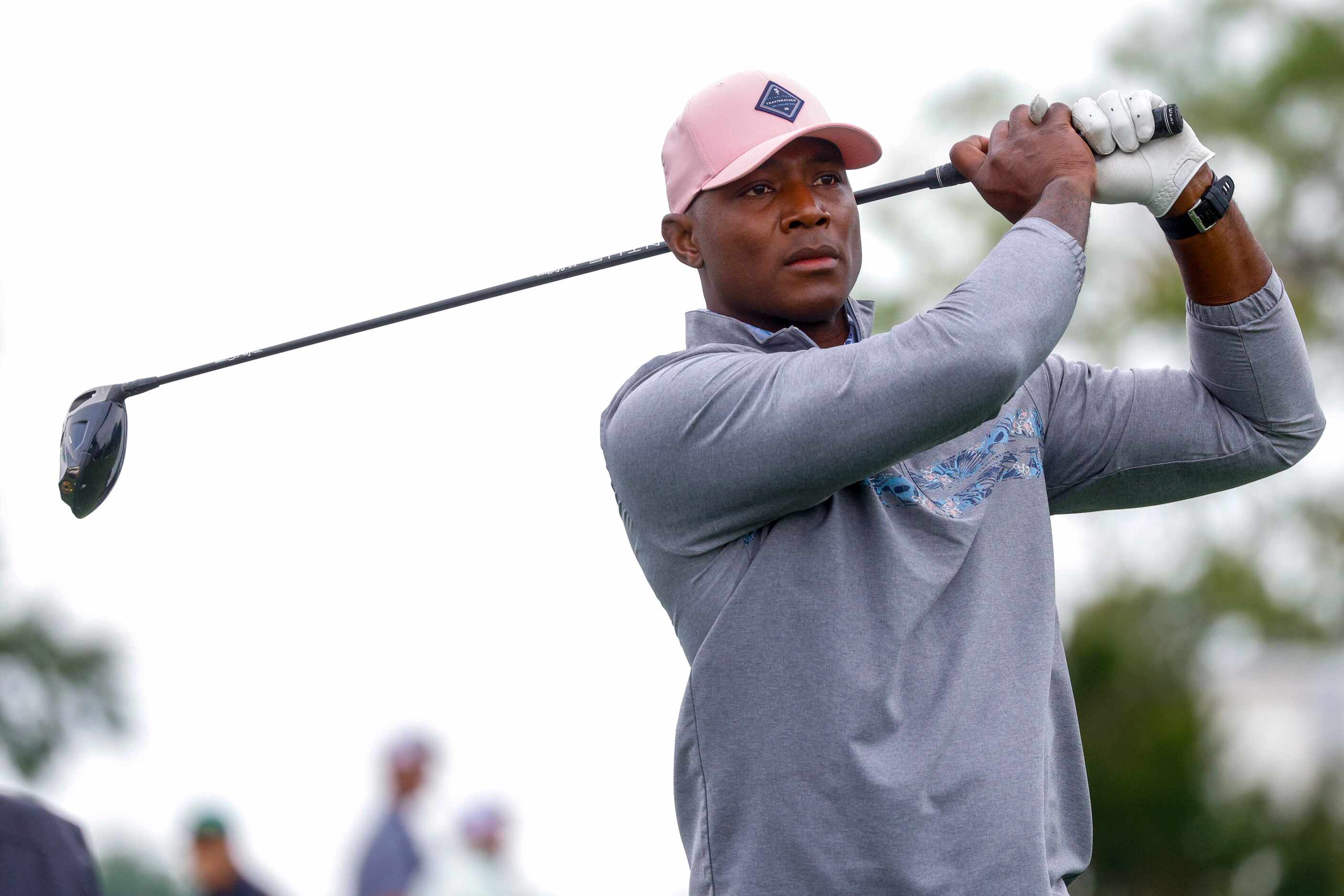 Former Dallas Cowboys player DeMarcus Ware watches his tee shot on the first hole during the...