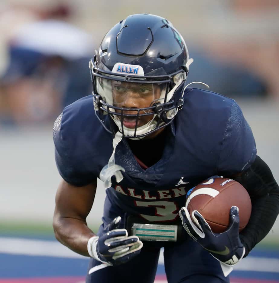 Allen High School wide receiver Caleb Smith (3) looks for room to run during the first half...