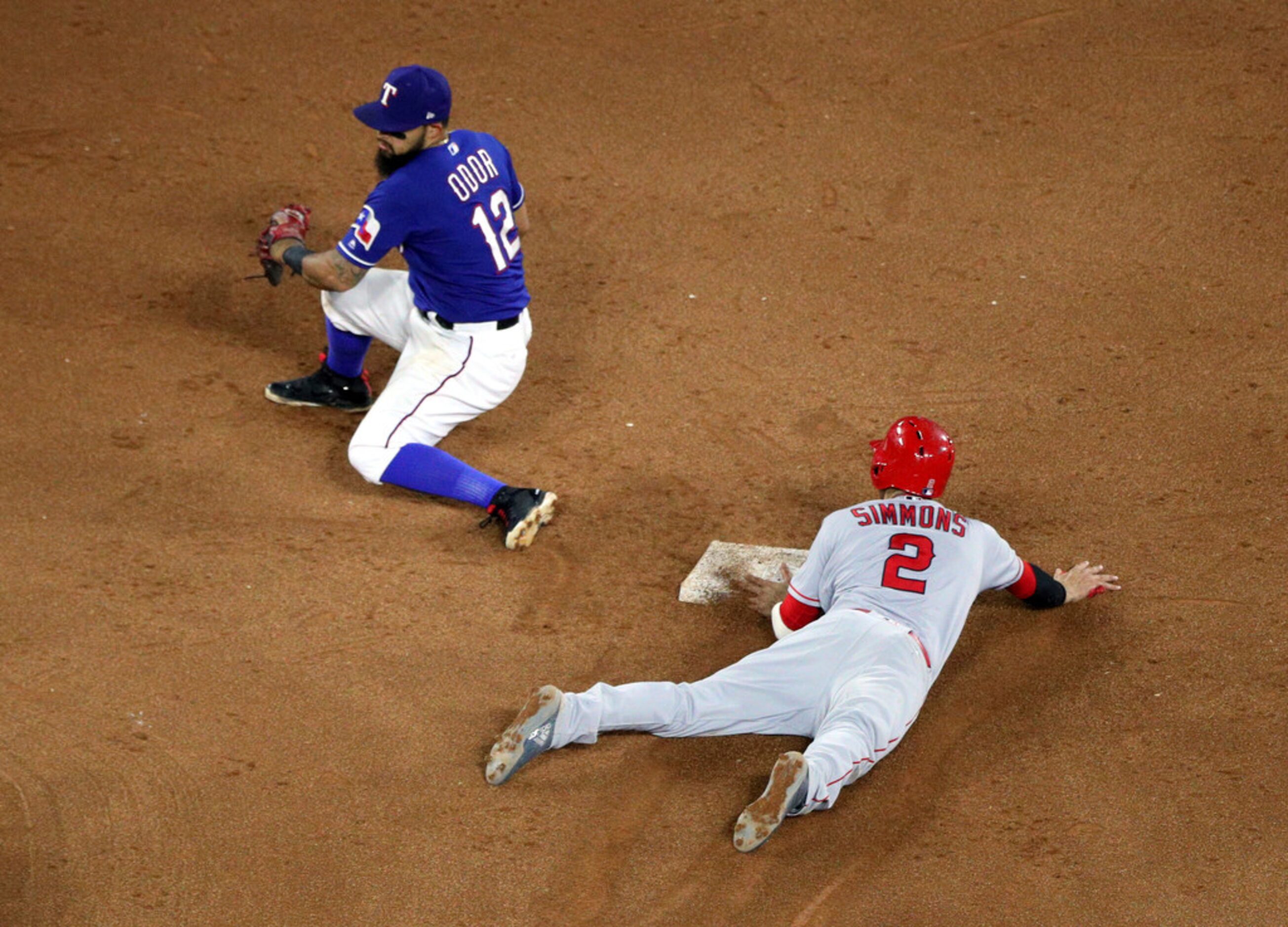 Texas Rangers second baseman Rougned Odor (12) gets the throw late as Los Angeles Angels'...