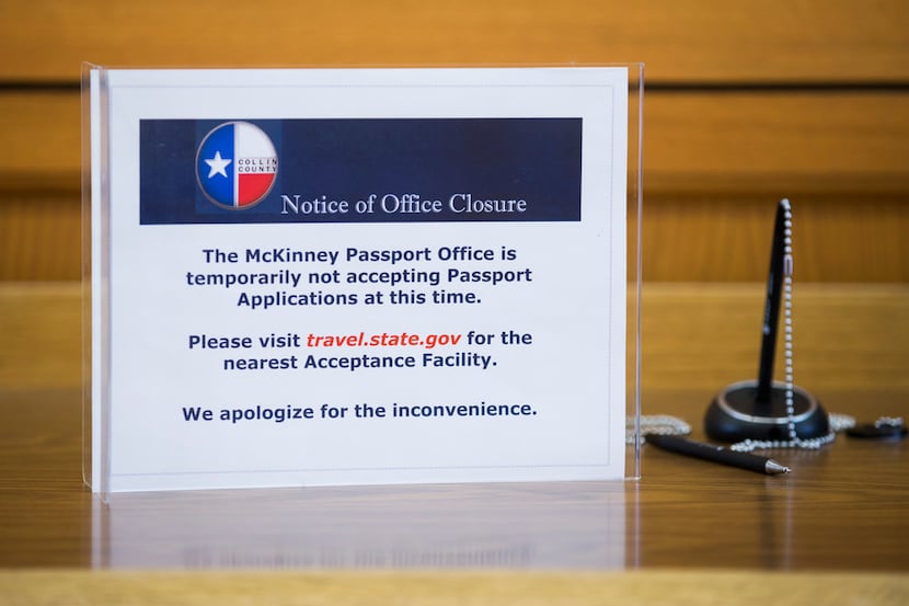 A sign notifies members of the public that the McKinney passport office is closed on...