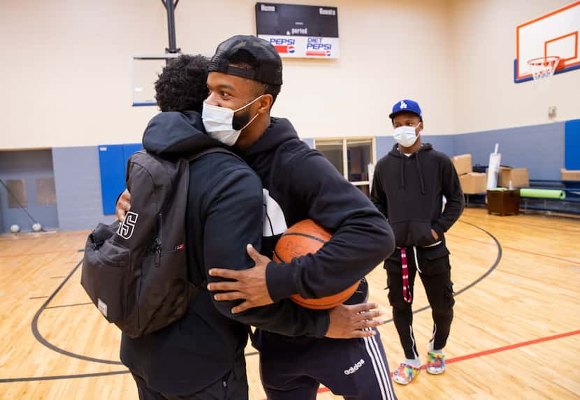 Xavier Henderson, left, For Oak Cliff's director of strategy, greets Frank Byers Jr. in the...