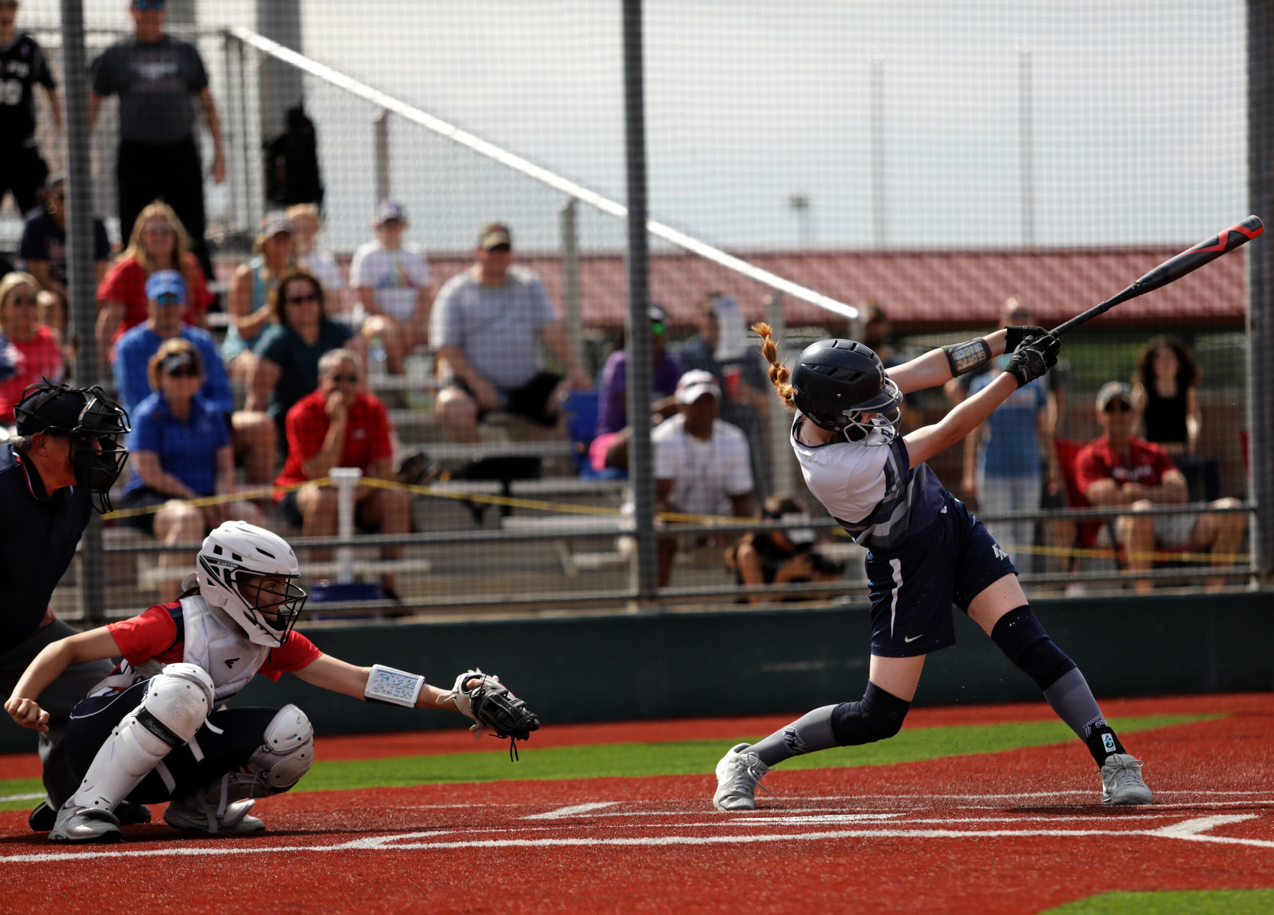 Flower Mound High School player #8, Carsyn Lee, swings for the ball during a softball game...