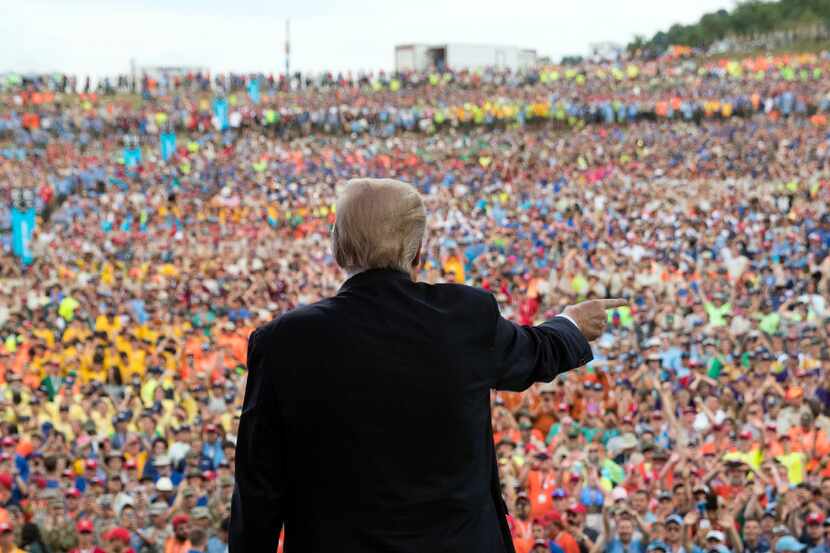 President Donald Trump gestures to the crowd after speaking at the 2017 National Scout...