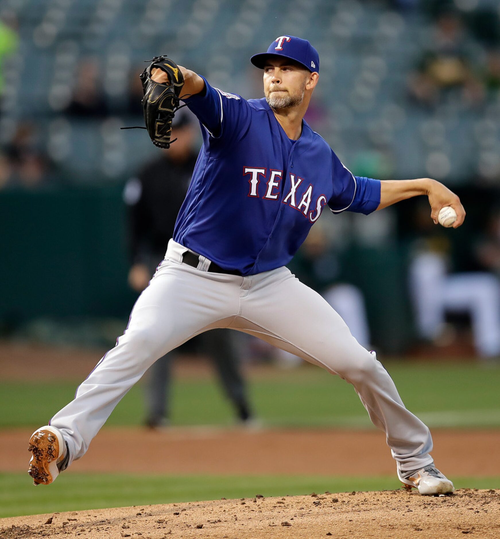 Texas Rangers pitcher Mike Minor works against the Oakland Athletics in the first inning of...