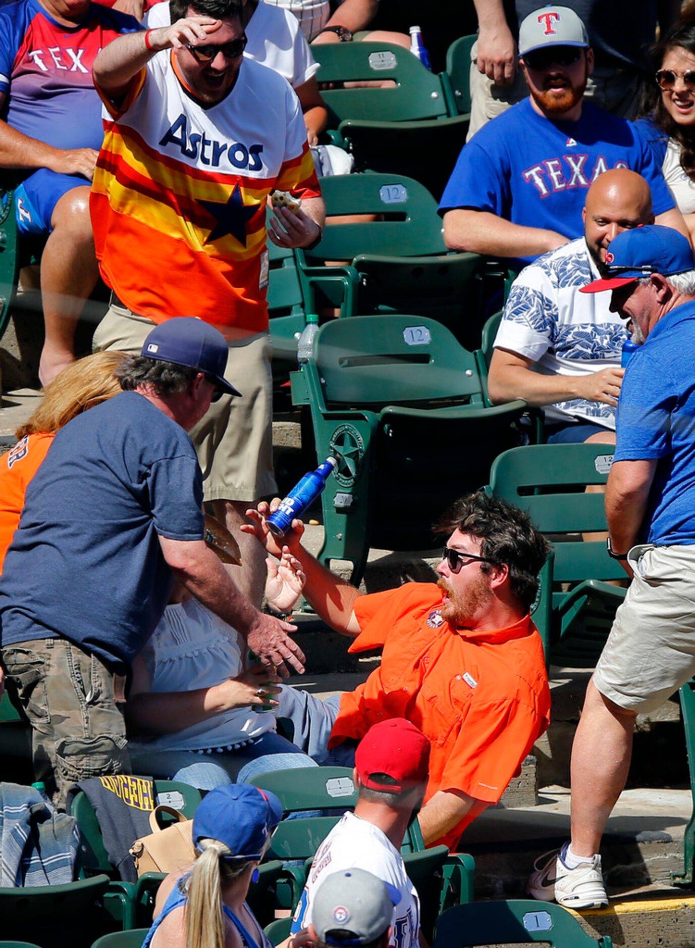 Series 2 of 4 -- One of the Houston Astros fans falls down the stairwell reach for the ball...