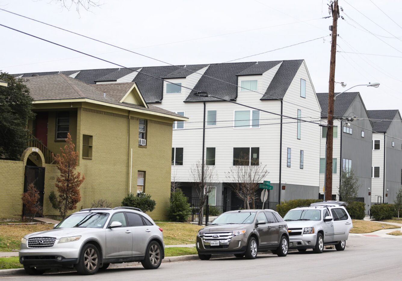 The Bryan Song Apartments, at left, in the shadow of the $340,000 condos across Grigsby Avenue.