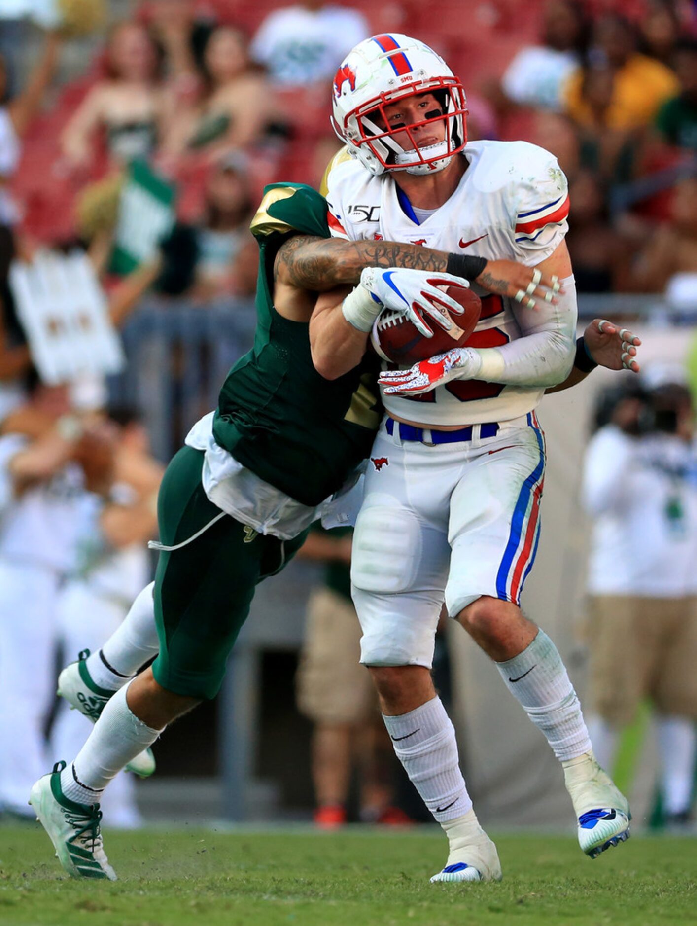 TAMPA, FLORIDA - SEPTEMBER 28: TJ McDaniel #25 of the Southern Methodist Mustangs makes a...