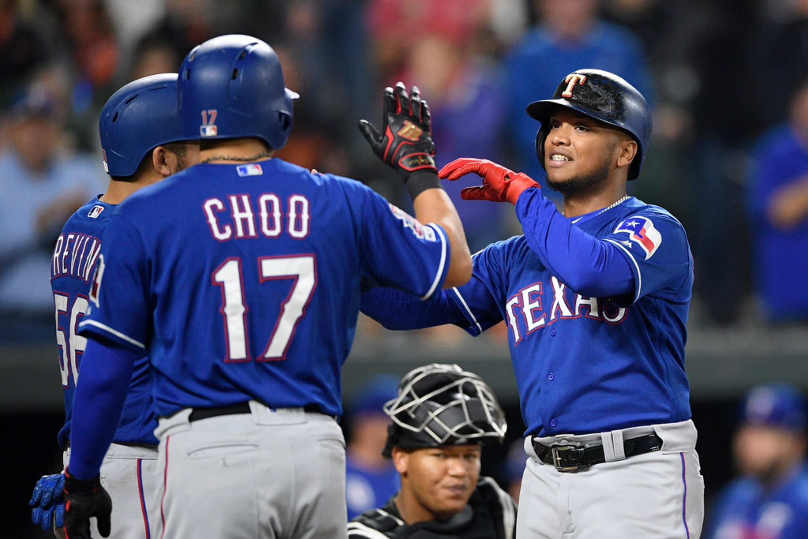 Texas Rangers' Willie Calhoun, right, celebrates his three-run home run with Shin-Soo Choo...