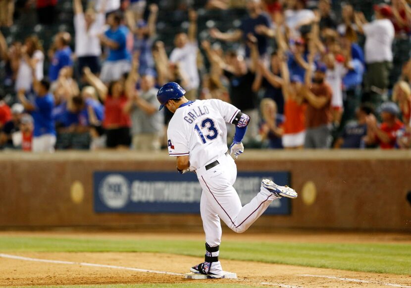 Texas Rangers third baseman Joey Gallo (13) rounds the bases after hitting a solo home run...