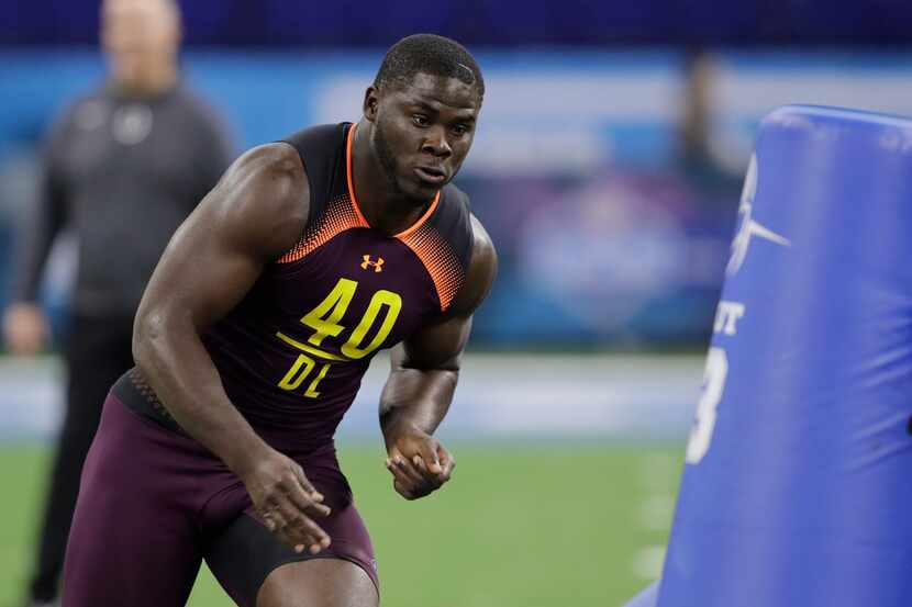 Miami defensive lineman Joe Jackson runs a drill during the NFL football scouting combine,...