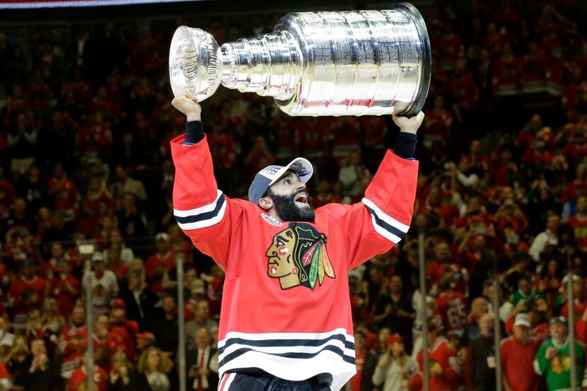 Chicago Blackhawks' Johnny Oduya, of Sweden, celebrates after defeating the Tampa Bay...