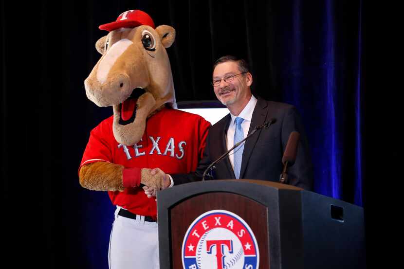 Texas Rangers mascot Captain shakes hands with Globe Life Accident Insurance president Bill...