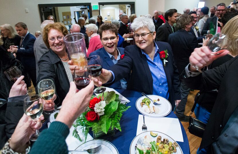 Linda and Beth Gerwe (center) toast after a mass celebration and blessing of marriage for 15...