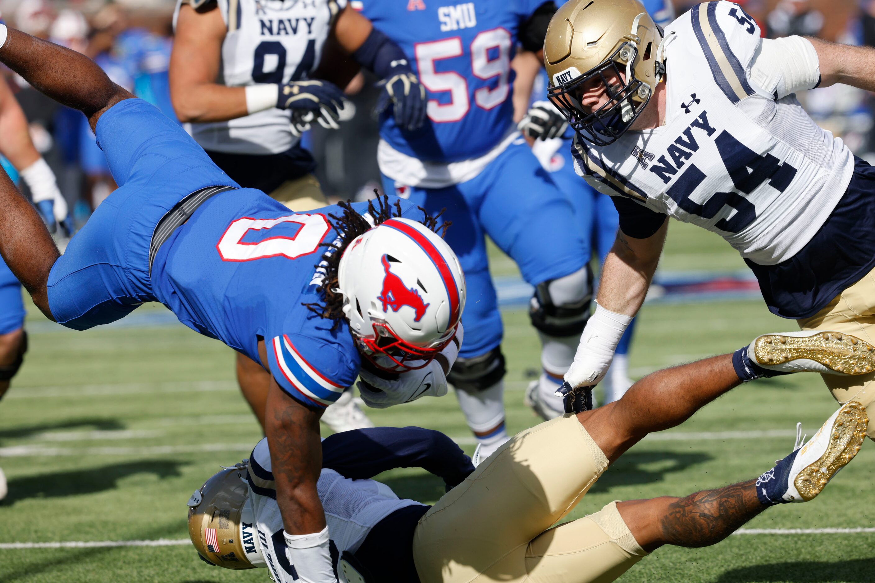 SMU running back Camar Wheaton (0) tries to score a touchdown over Navy safety Rayuan Lane...