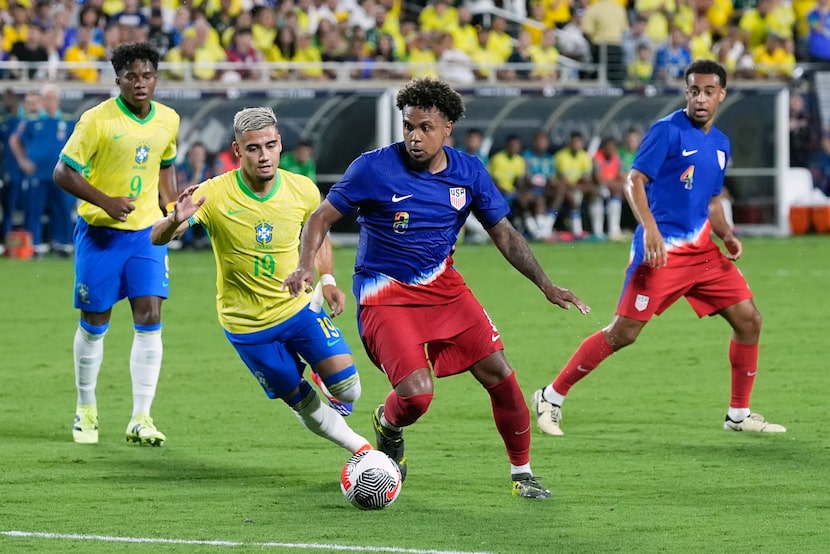 U.S. midfielder Weston McKennie, front right, moves the ball past Brazil midfielder Andreas...