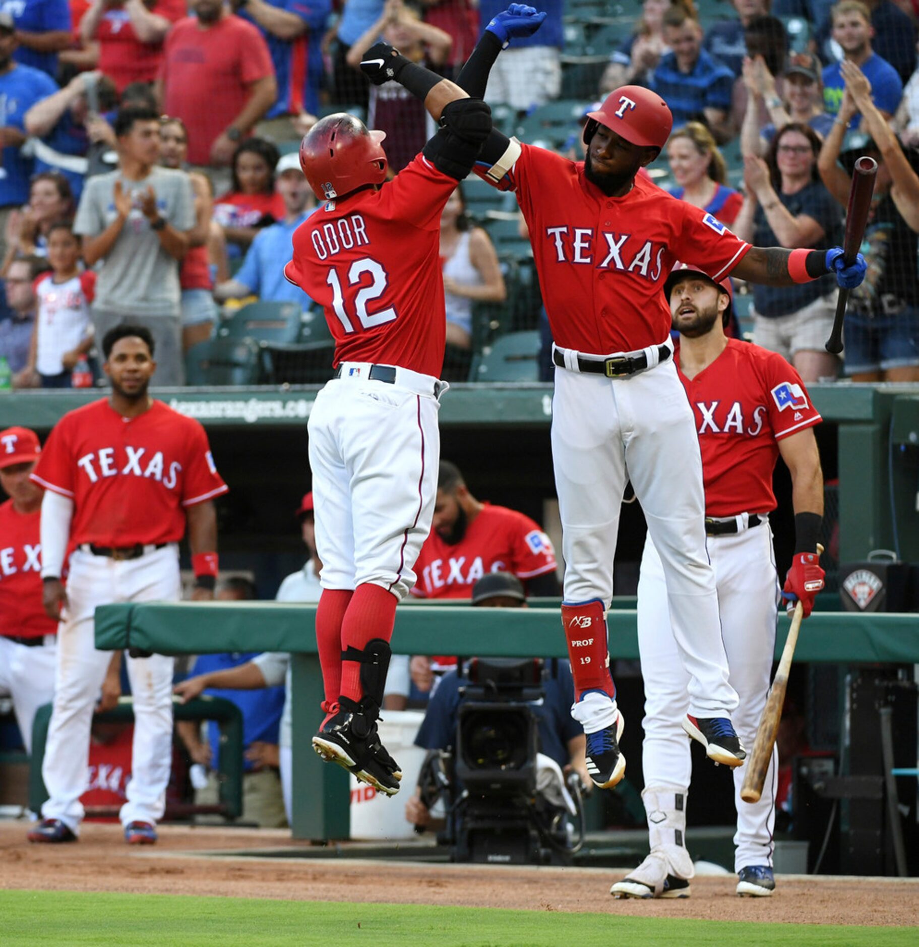 Texas Rangers' Rougned Odor (12) and Jurickson Profar, right, celebrate Odor's solo home run...