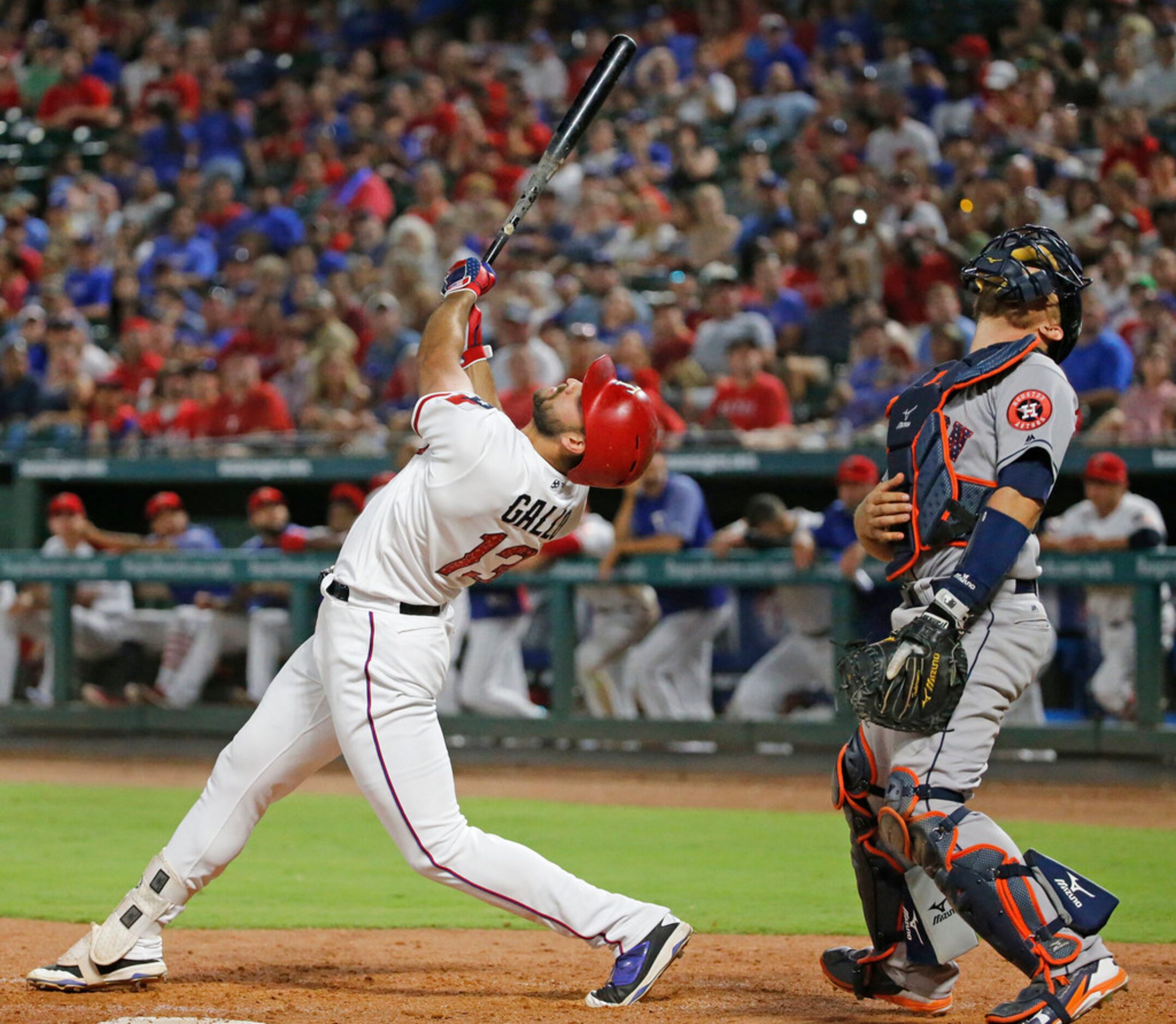 Texas Rangers Joey Gallo (13) and Astros catcher  Tim Federowicz watch the flight of a foul...