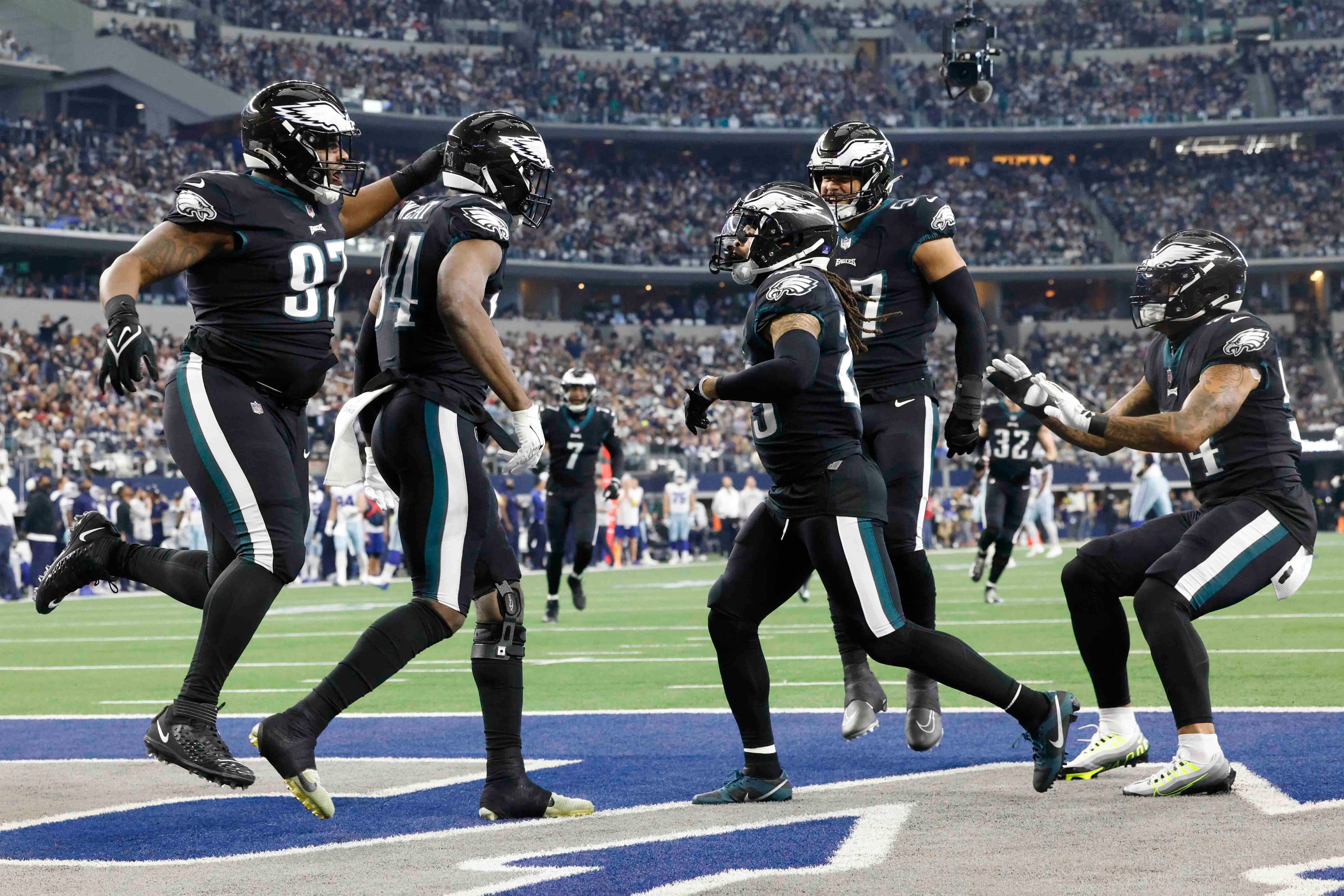 Philadelphia Eagles defensive end Josh Sweat (94), second from left, celebrates a touchdown...