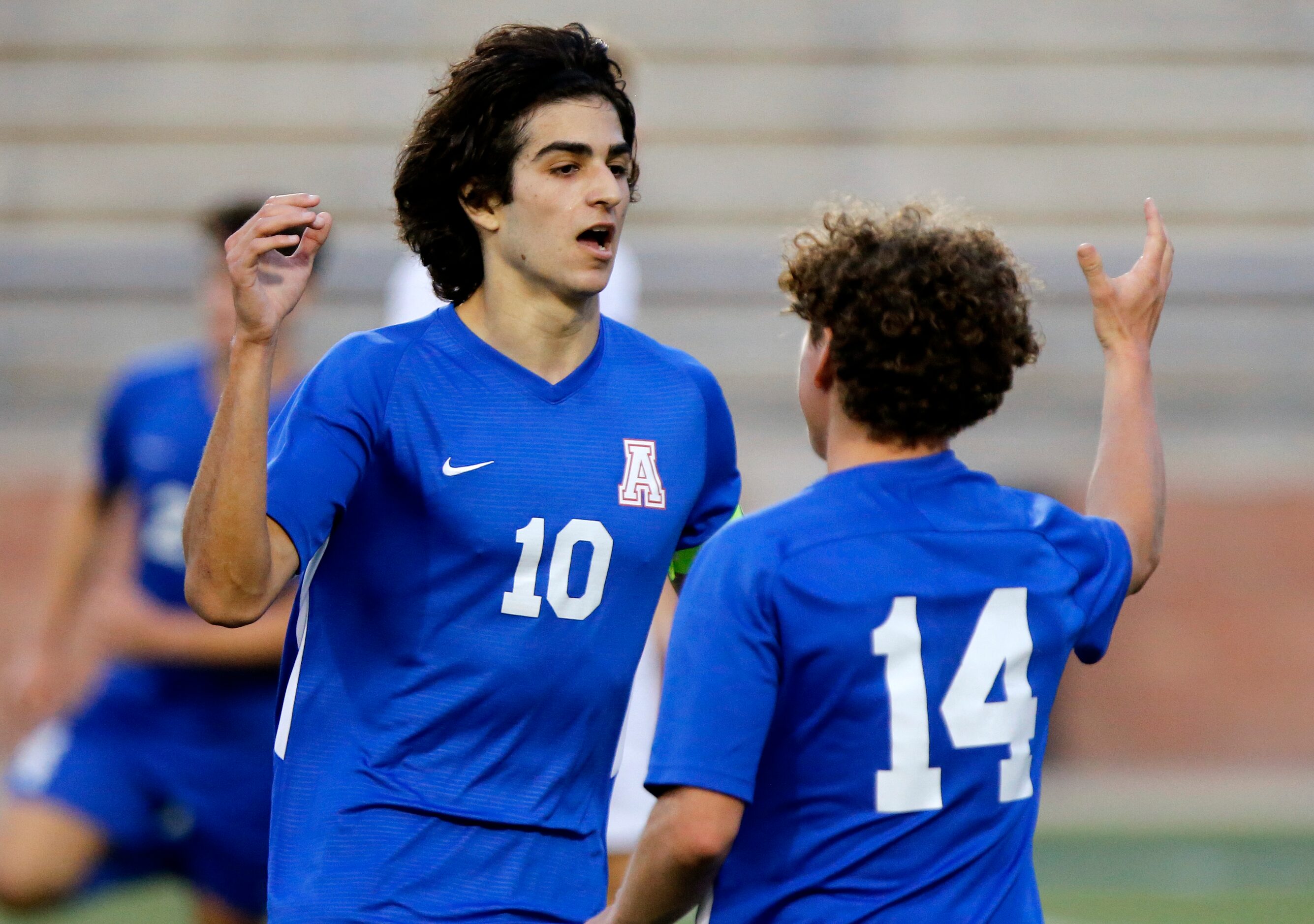 Allen midfielder Sam Presser (10) is congratulated by forward Matthew Sanchez (14) after...