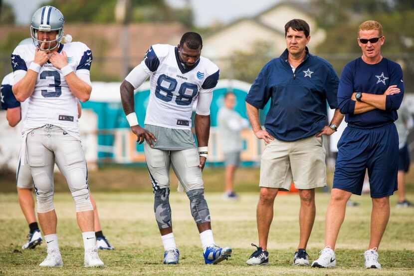Dallas Cowboys wide receiver Dez Bryant (88) grabs his left hamstring as he sits out a drill...