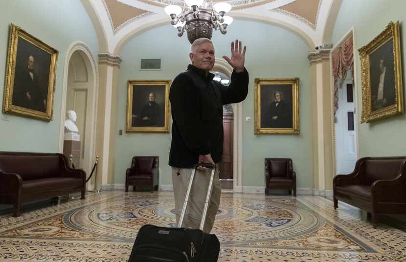 Rep. Pete Sessions, R-Dallas, waved to reporters as he departed the U.S. Capitol on Dec. 22,...