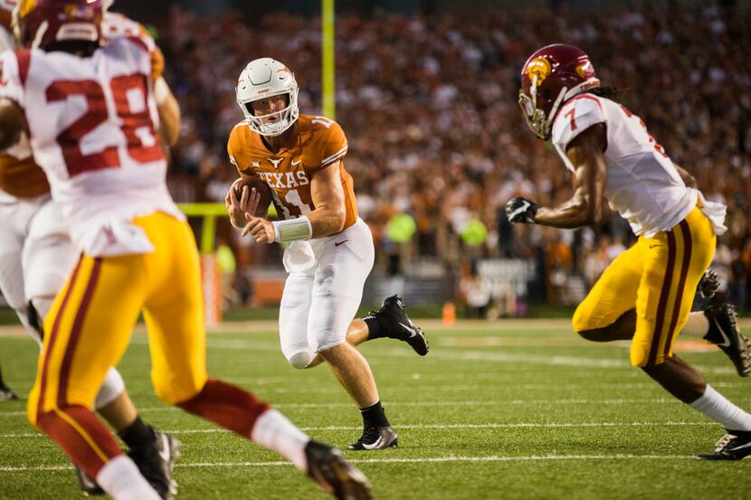 Texas Longhorns quarterback Sam Ehlinger (11) runs the ball during the first quarter of an...