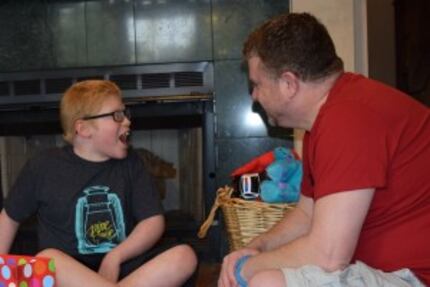  Ben Schneider reacts as his dad, Rob Schneider, gives him a Ben Folds T-shirt on his...