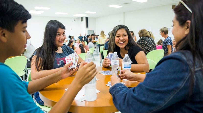 
Alex Paniagua (left), Mariah Ann, Calista Martinez and Calette Benavidez play cards during...