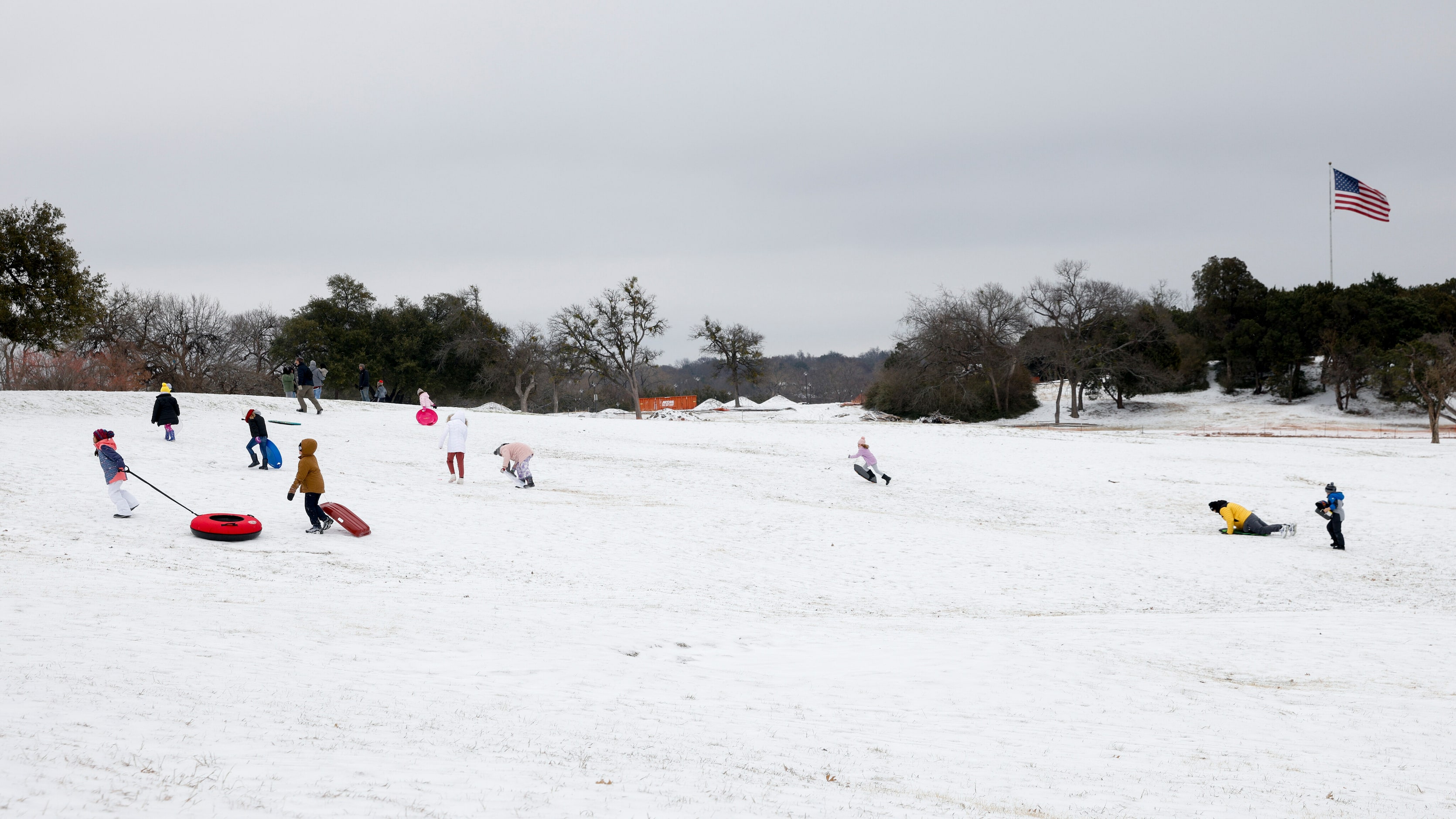 Families and friends sled at Flag Pole Hill in Dallas, Tuesday, Jan. 31, 2023. Freezing rain...