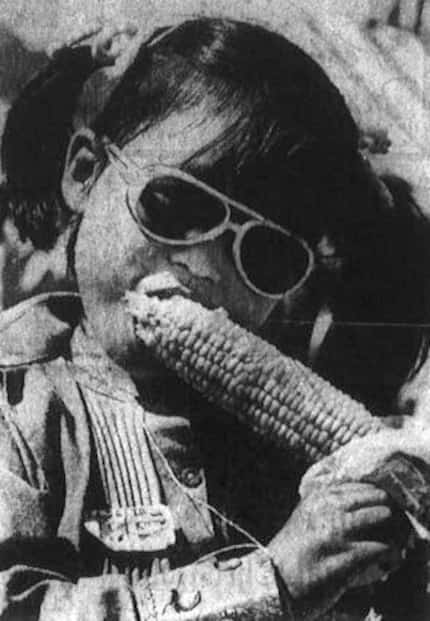 A photo in a news clipping from 1974 shows Catherine Harned biting into a cob of corn at the...