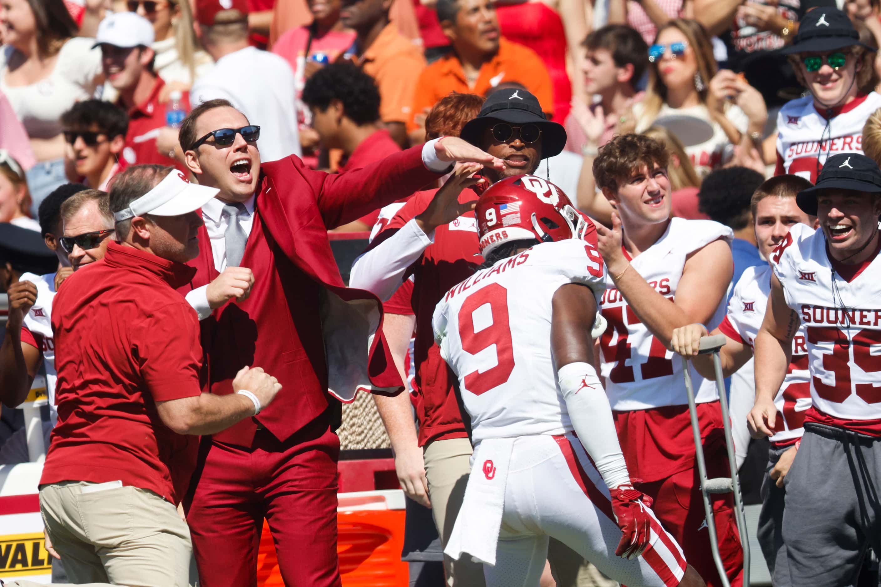 Oklahoma sideline cheer upon Oklahoma defensive back Gentry Williams (9) after intercepting...