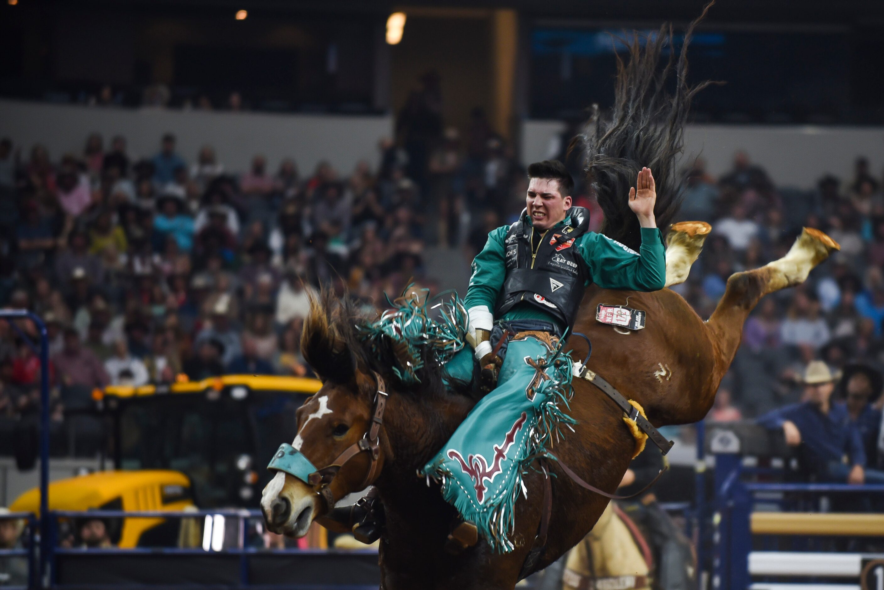 Jesse Pope attempts to stay on his horse as a part of the Bareback Bronc event during the...