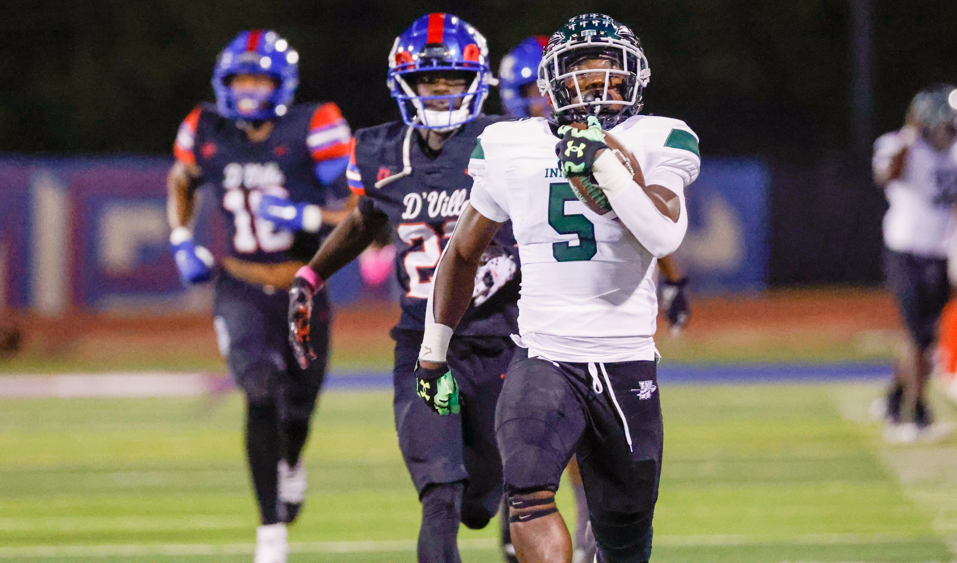Waxahachie running back Jayden Becks (5) runs ahead of Duncanville defense in to the end...