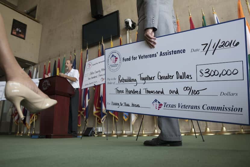 From 2016, Jake Ellzey, Commissioner of Texas Veterans Commission holds a check written to...