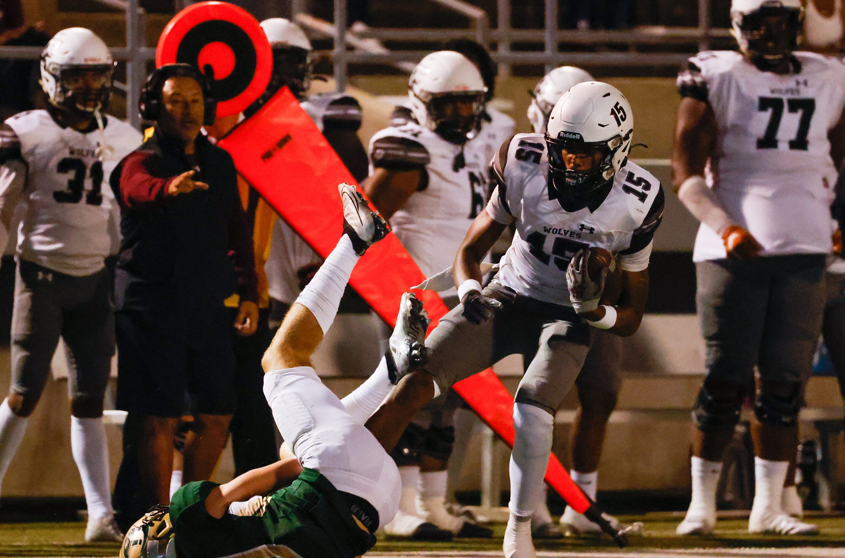 Mansfield Timberview wide receiver Titus Evans (6) dodges Birdville defenders in the first...