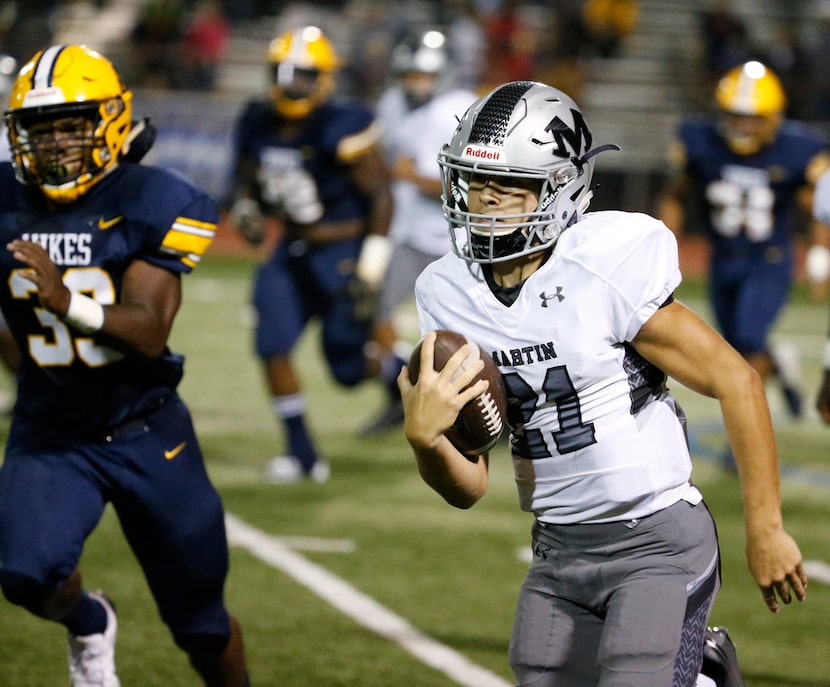 Arlington Martin's quarterback Zach Mundell runs the ball against Arlington Lamar in the...