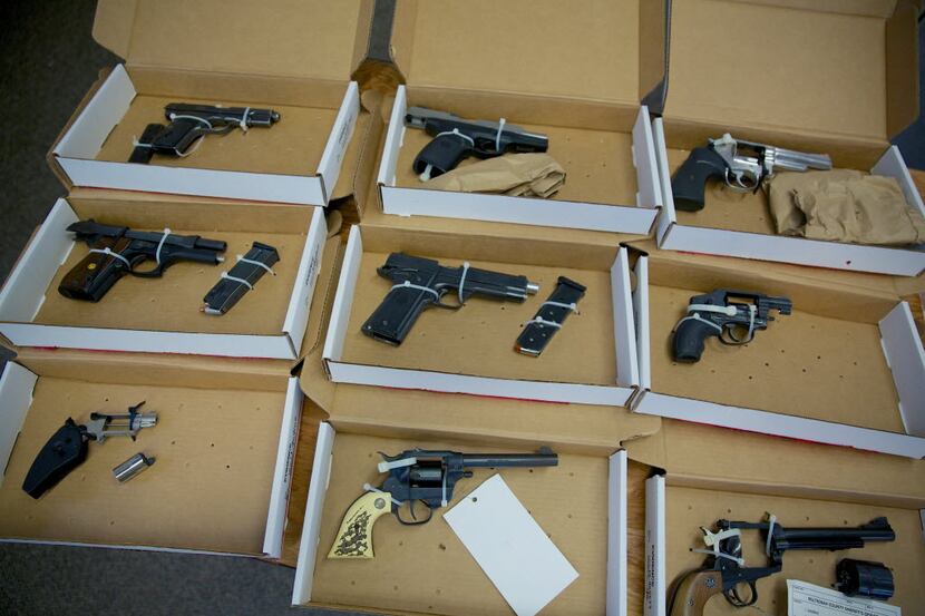 In this Dec. 9, 2013 photo, firearms evidence is on display during a news conference in...