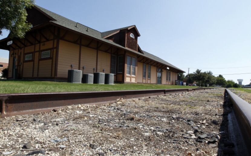 Railroad tracks outside the Allen Heritage Center are a reminder of the town's growth in the...
