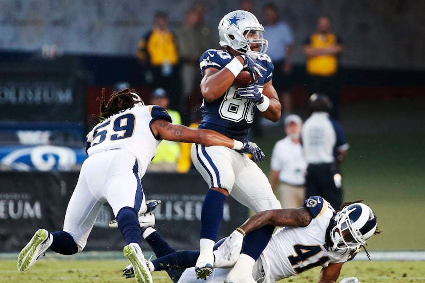 Dallas Cowboys tight end Rico Gathers (80) catches the ball amongst Los Angeles Rams outside...
