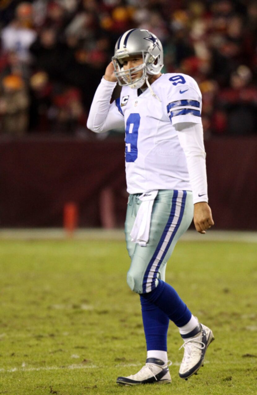 A dejected Dallas Cowboys quarterback Tony Romo (9) after throwing his second interception...