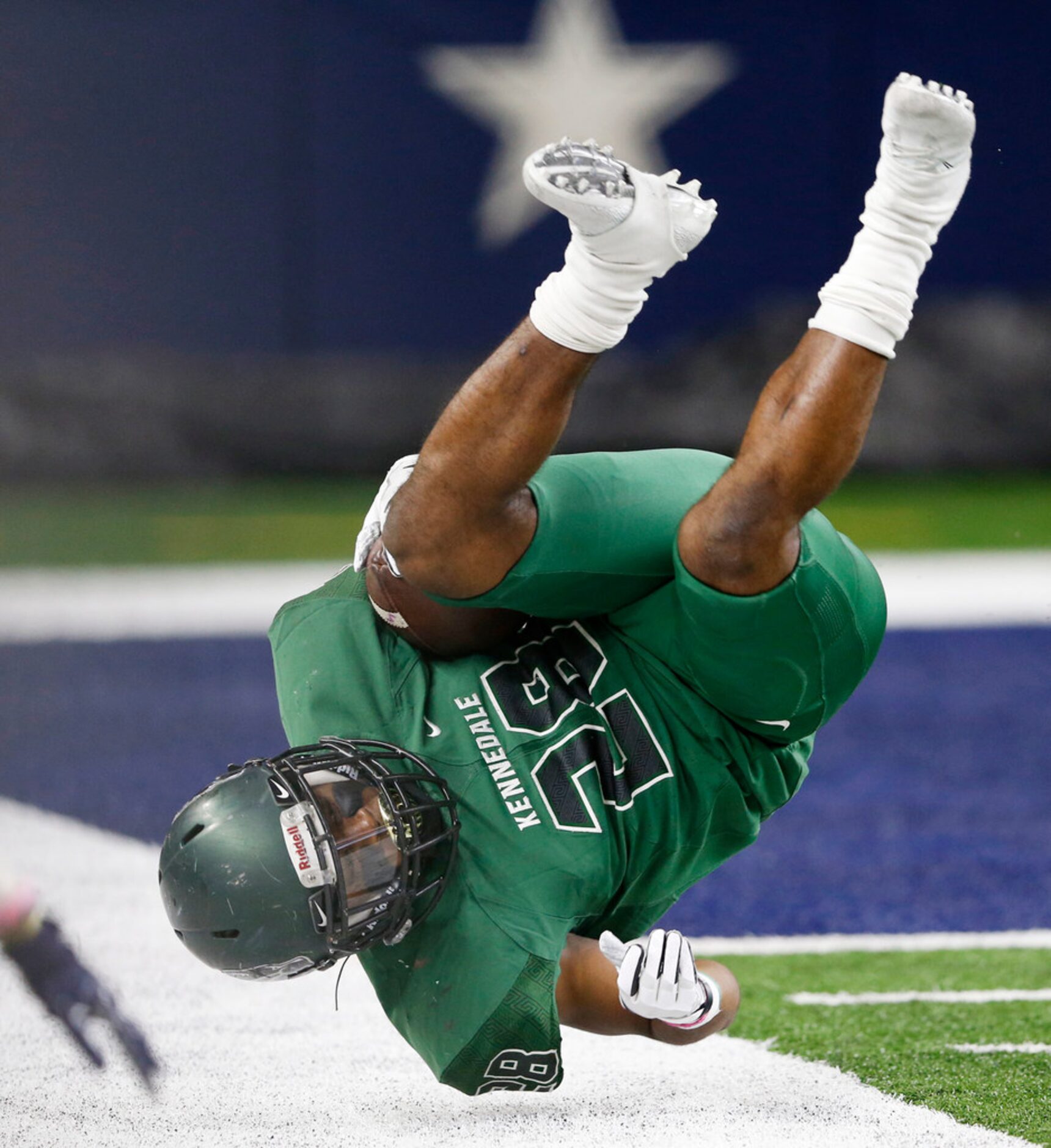 Kennedale's DJ Kirven (28) flips over as he is tackled near the goal line in a game against...