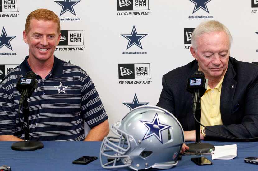 Dallas Cowboys coach Jason Garrett smiles as owner Jerry Jones speaks at a pre-draft press...