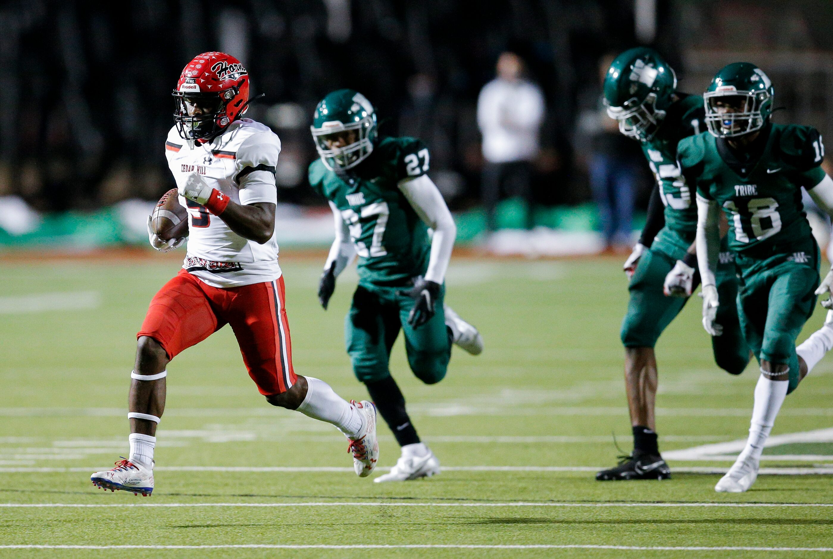 Cedar Hill senior running back Kevin Young Jr. (5) breaks past the Waxahachie defense to...