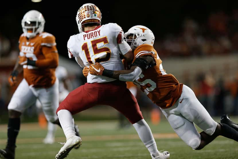 AUSTIN, TX - NOVEMBER 17:  Brock Purdy #15 of the Iowa State Cyclones is hit after throwing...