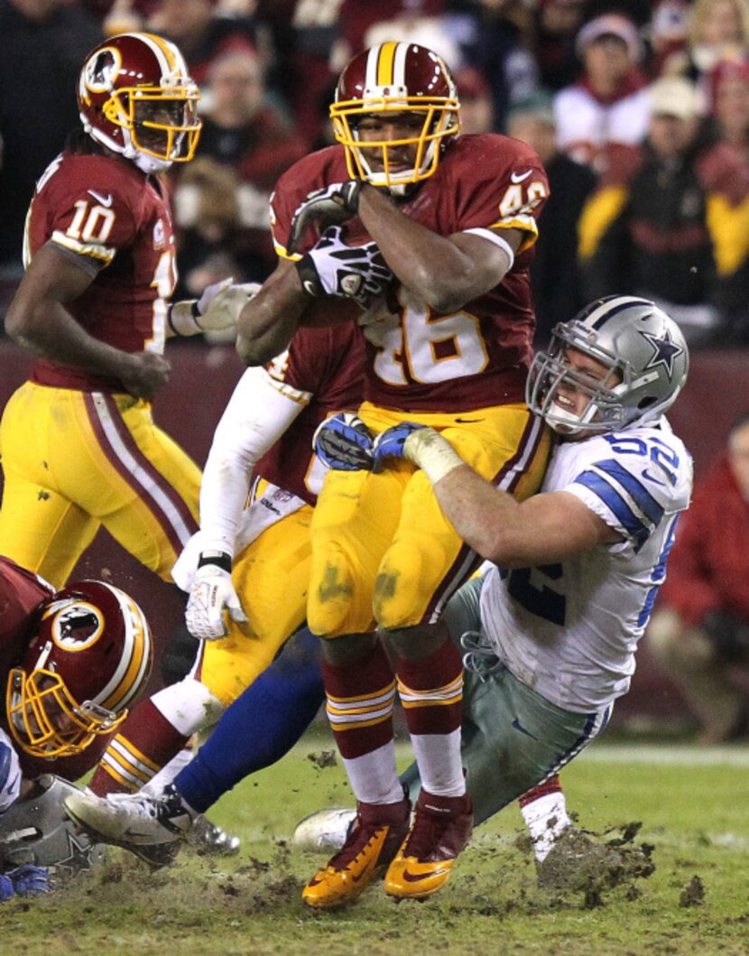 Washington Redskins running back Alfred Morris (46) bowls into Dallas Cowboys inside...