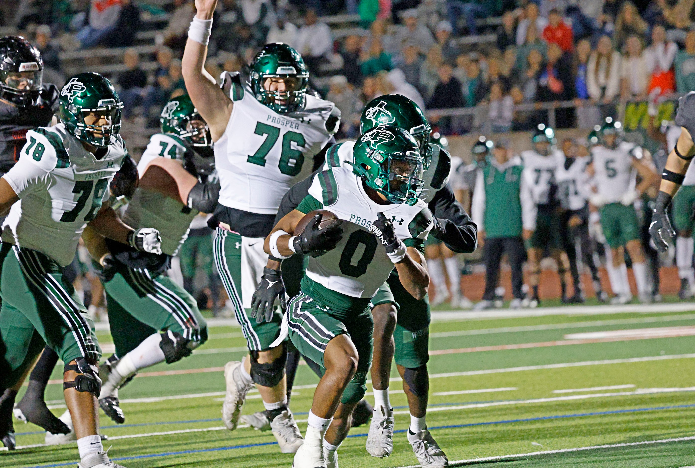 Prosper's Leo Anguiano (0) runs for a touchdown as his teammates follow him in the first...